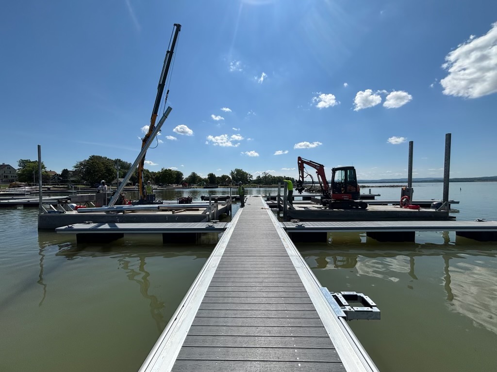 Crane setting new aluminum dock sections during a marina installation