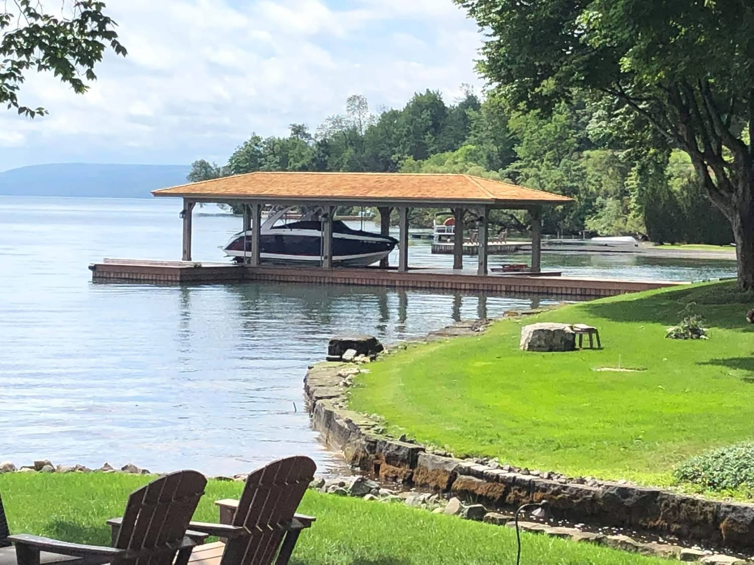 New timber boathouse with boat lift on a Finger Lakes shoreline
