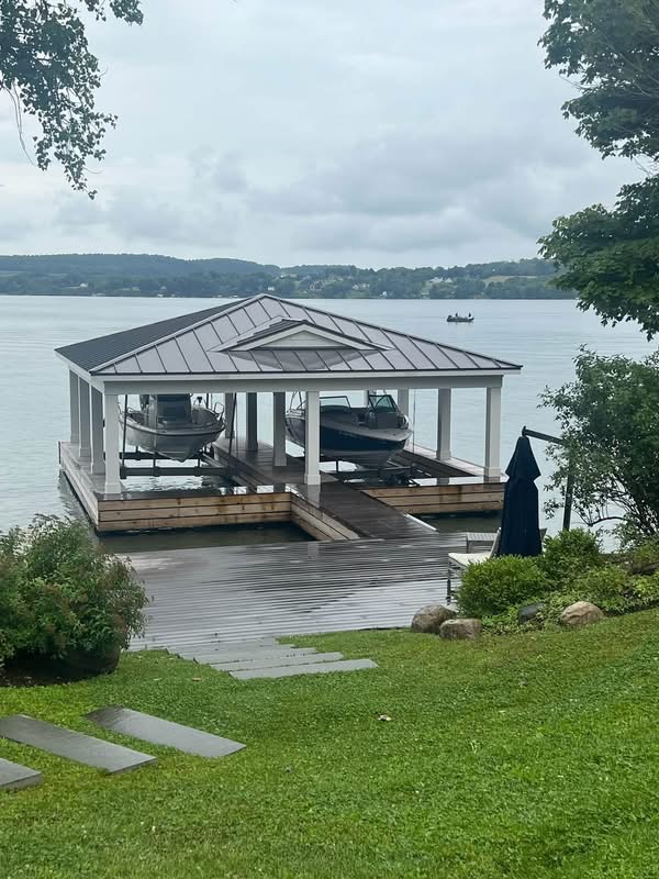 Covered two-slip boat dock with metal roof on a lakefront property