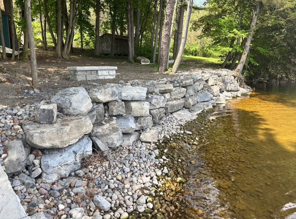 Natural stone rock retaining wall built along a shoreline