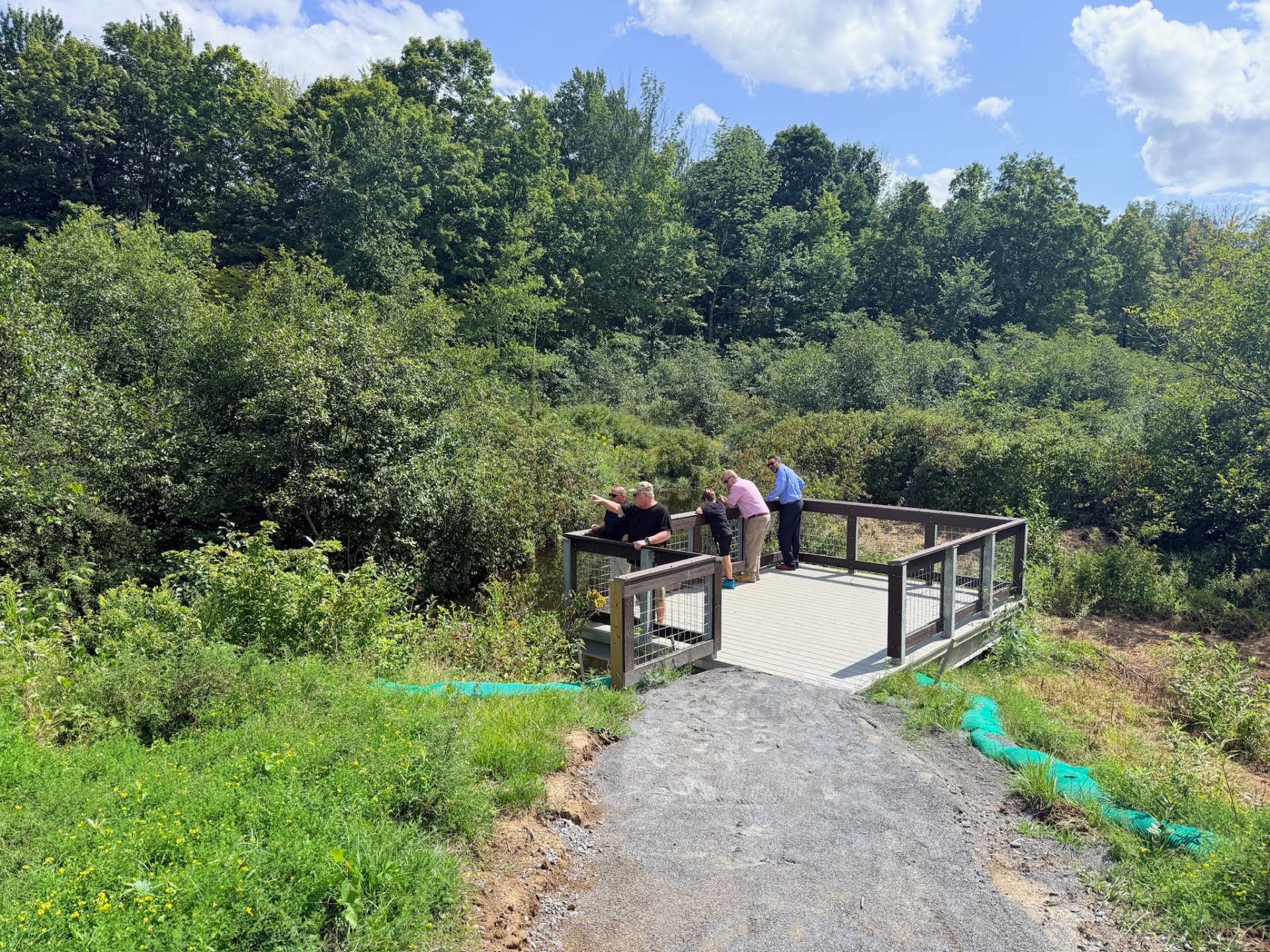 Visitors on the new accessible fishing platform overlooking the Snook Kill in Wilton, NY