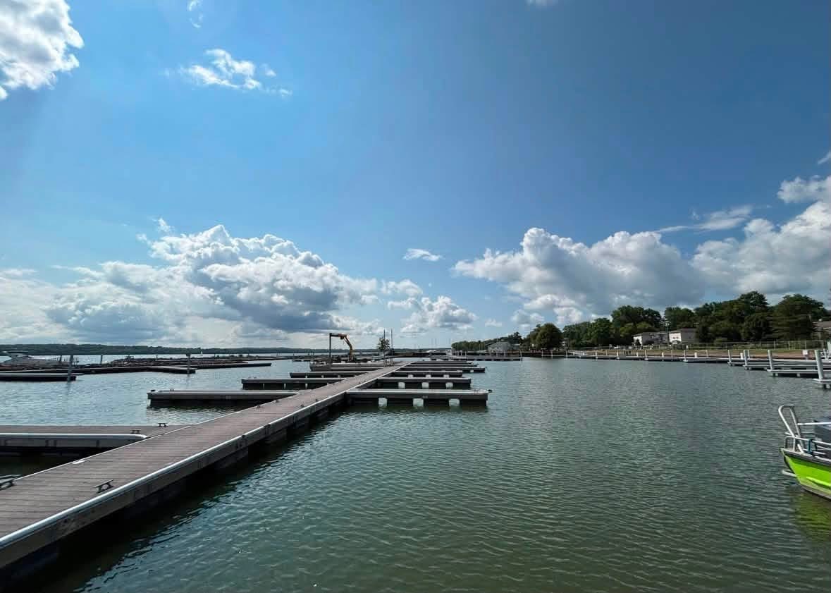 Marina dock installation in progress with excavator working on shore